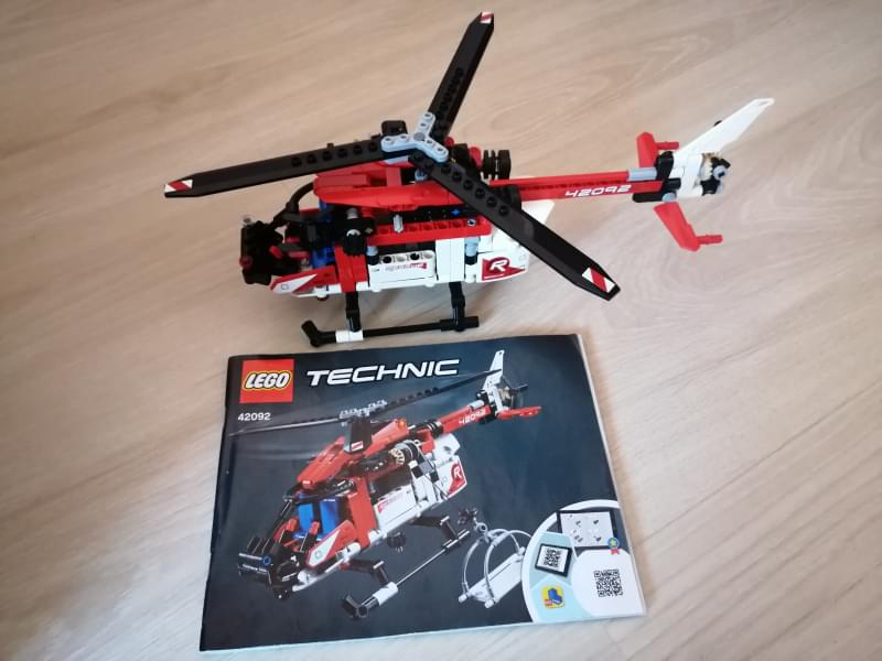 A finished Lego Technic rescue helicopter with the instruction booklet