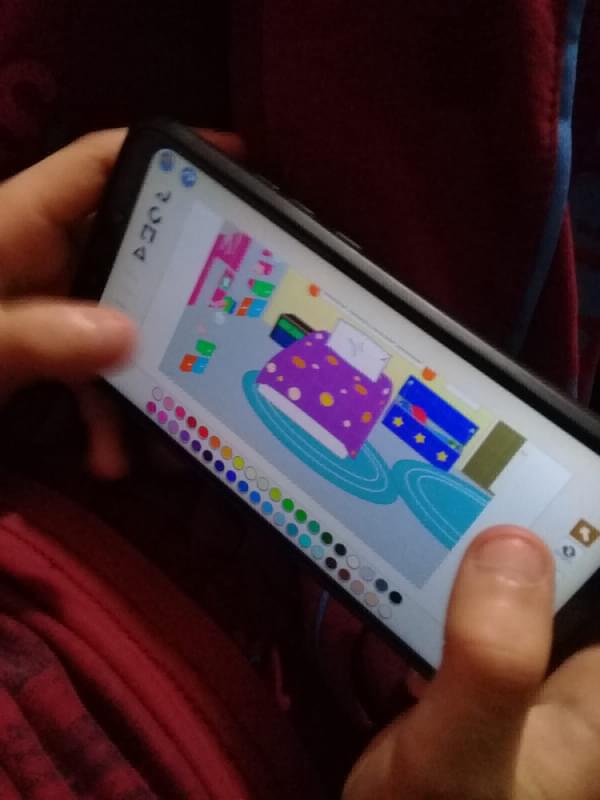 A mobile phone showing a screen in the Scratch app